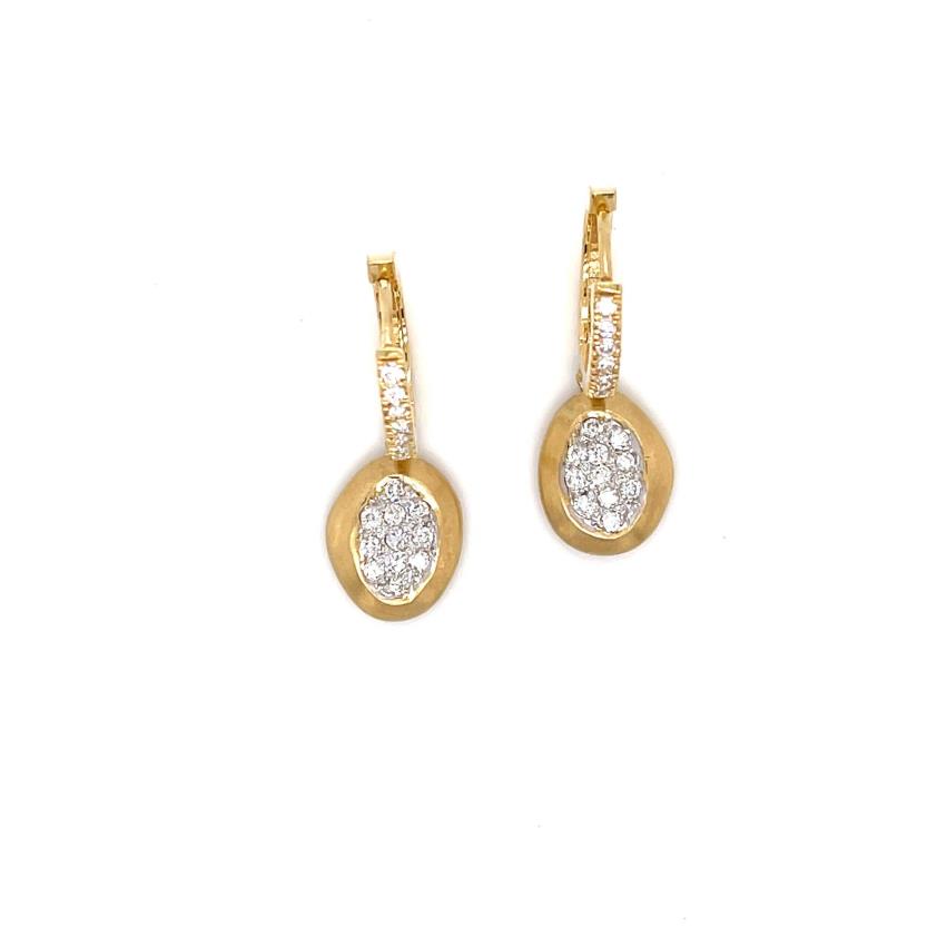 Circular gold earrings with an oval-shaped dropped charm with a diamond in the center.